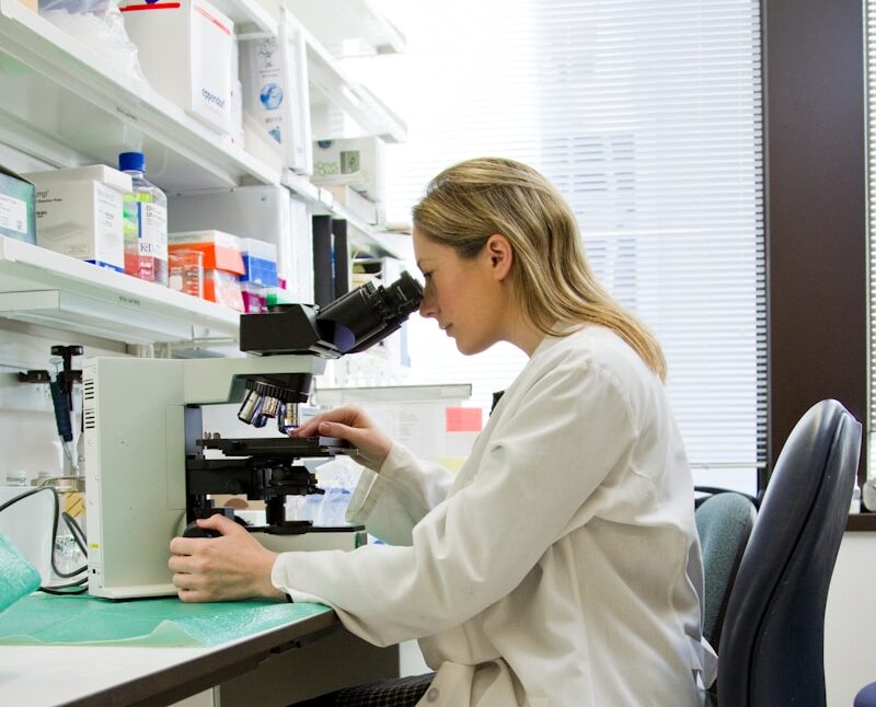woman in white robe sitting on black office rolling chair